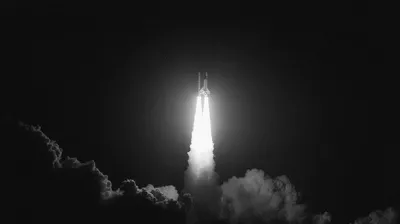 abstract rocket going up into the air, pure black to white gradient, smooth cinematic grain overlay, classic film noir l