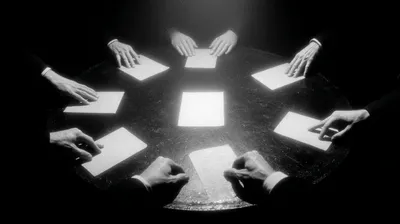 black and white film noir photograph from directly above, round table in center with a single illuminated document, seve