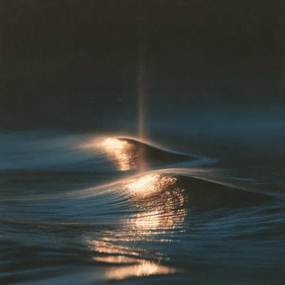 An abstract icon of duplicated effort: two nearly identical luminous gold waves collide and blur into a heavy muted-indi