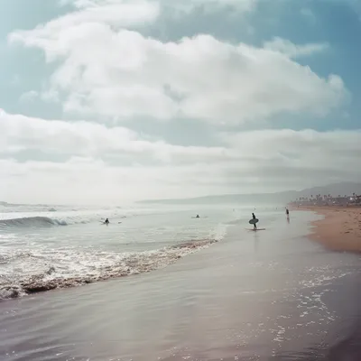 wide open beach with surfers in Southern California