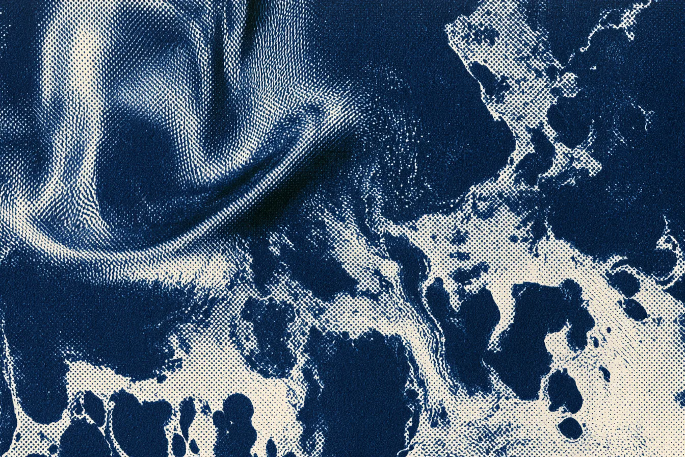 abstract macro study of liquid potassium metal, treated as a graphic material rather than a literal object: a smooth poo